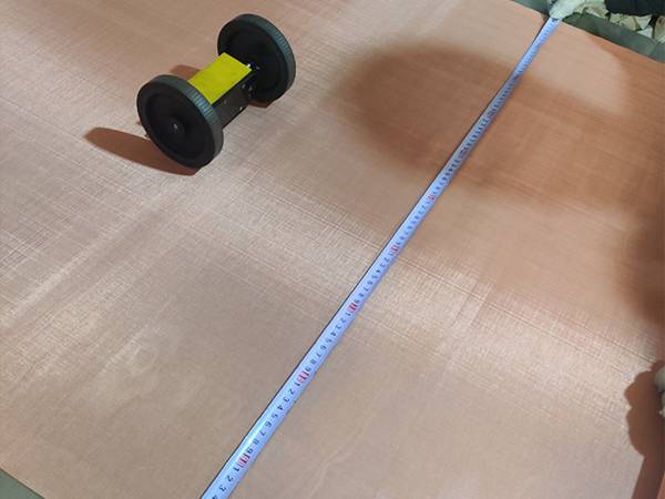 Measure the width of copper woven mesh with a tape measure