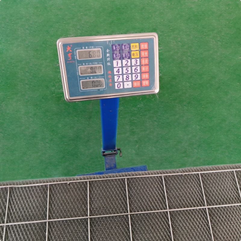 A piece of demister pad is placed on the weighing machine.