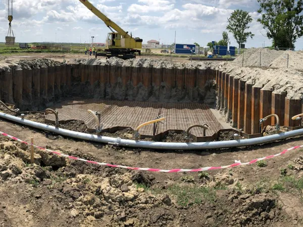 Construction site of a building foundation pit with drainage pipes