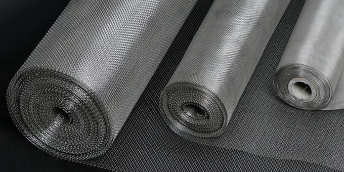 Several rolls of stainless steel woven wire mesh with different mesh sizes.