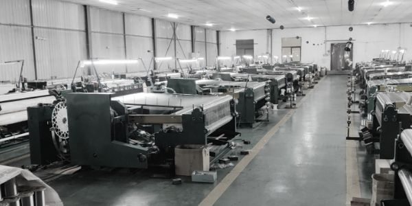 Two rows of German weaving machines are