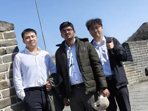 Group photo of manager and Indian partners at the Great Wall