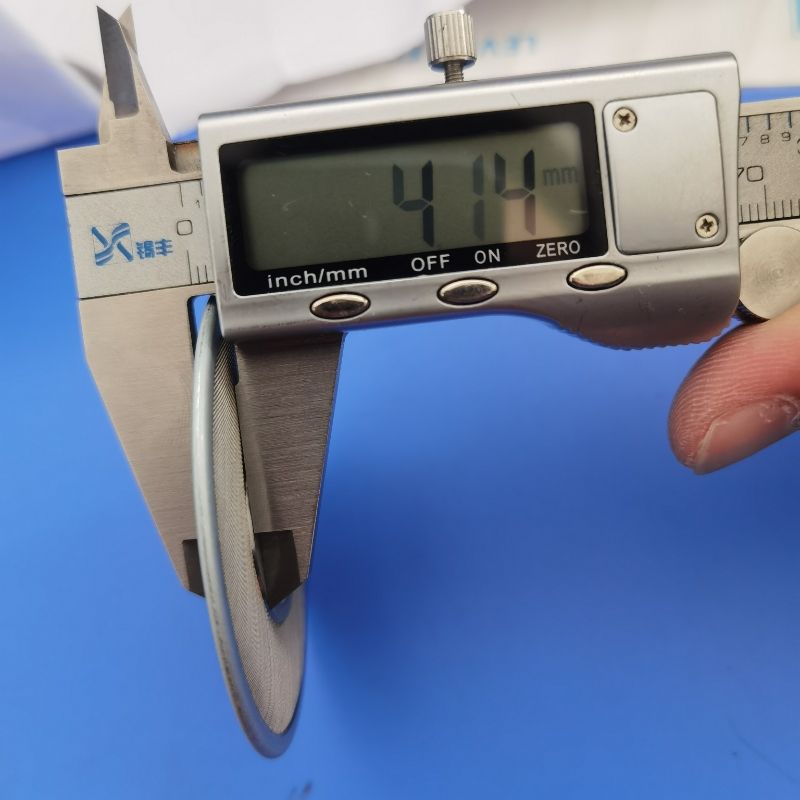 A caliper is used to measure the thickness of the polymer leaf disc filter.