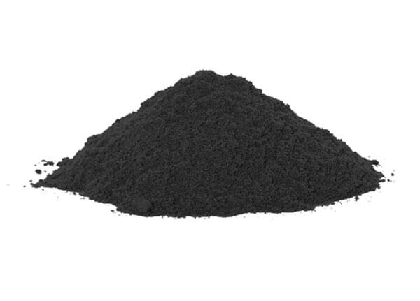 Black Raney Nickel powder placed on white tabletop