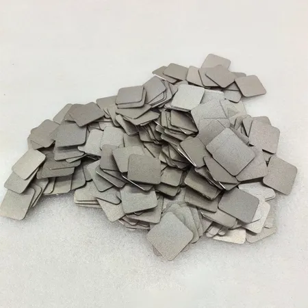 A square, sheet-like sintered porous sheet on a gray background