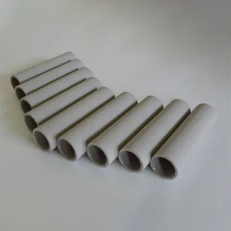A row of sintered porous tubes arranged side-by-side on a gray background